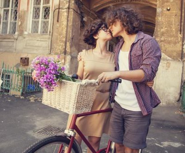 Couple with bike near house.