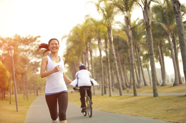 healthy lifetyle asian woman jogging at tropical park