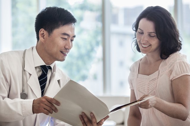 Doctor and patient sitting down and discussing medical record in the hospital