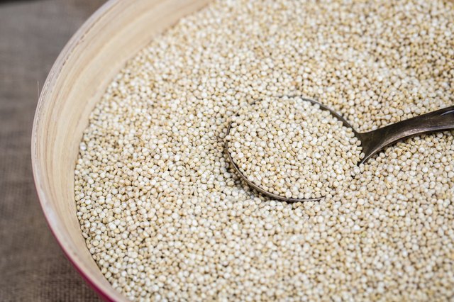 Organic quinoa grain in wooden bowl