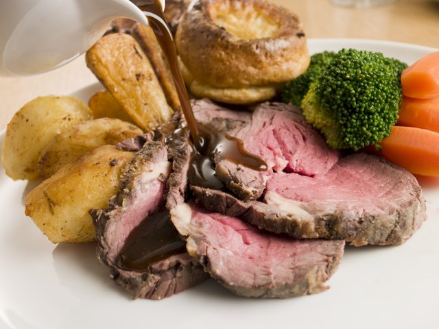 Gravy being Poured on a plate of Roast Beef