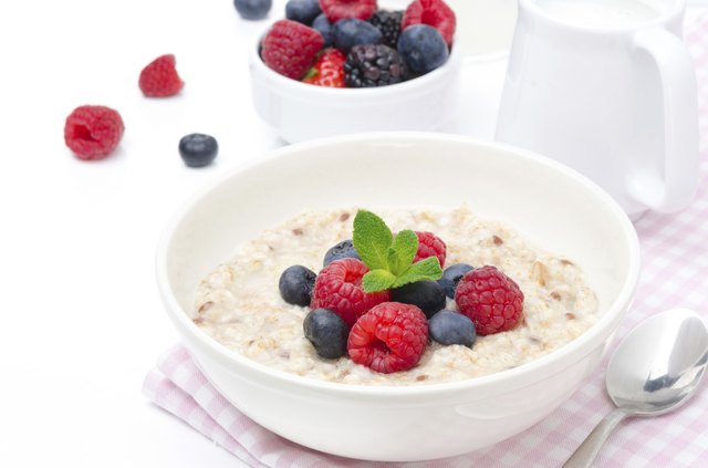 healthy breakfast - oatmeal with fresh berries isolated on white