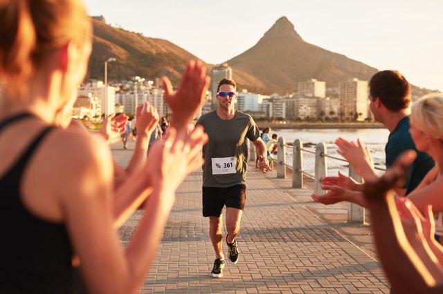 Young people encouraging runners at finish line