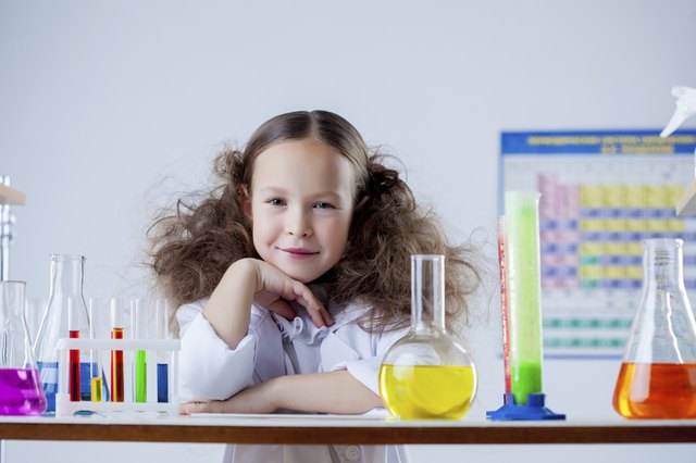 Portrait of smiling adorable girl posing in lab