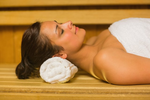 Peaceful brunette relaxing in a sauna