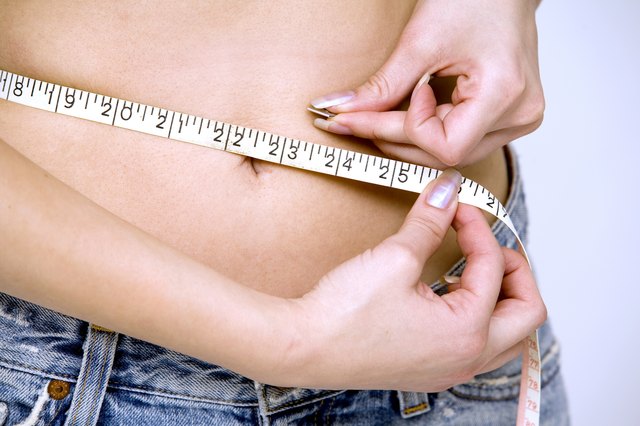 girl measuring her waist