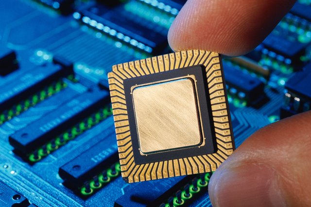 Hand holding computer chip, close-up