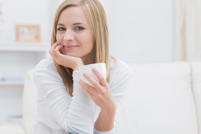 Portrait of woman with tea cup at home