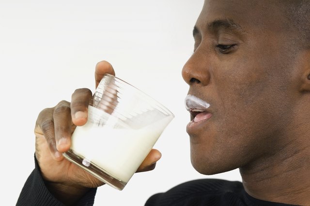 Man drinking milk and having a milk mustache, close-up