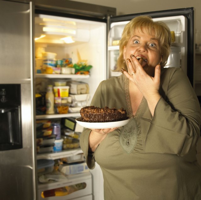 Woman shoving cake in her mouth