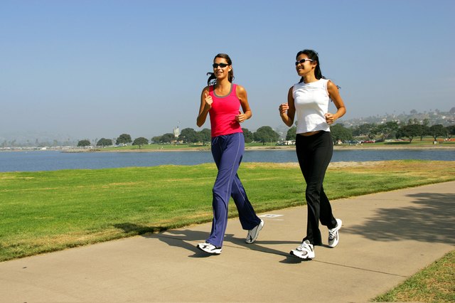 Two women jogging on the seafront.