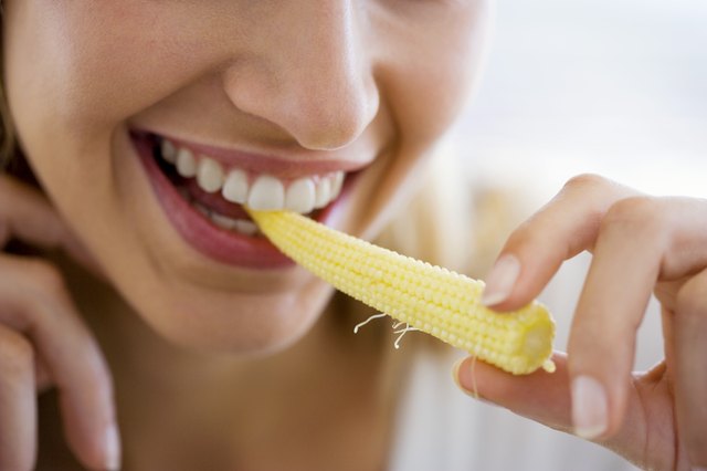 Woman eating corn