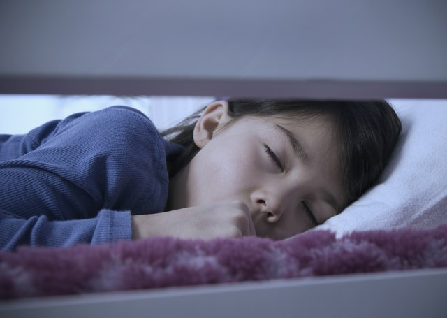 Asian girl sleeping in bed