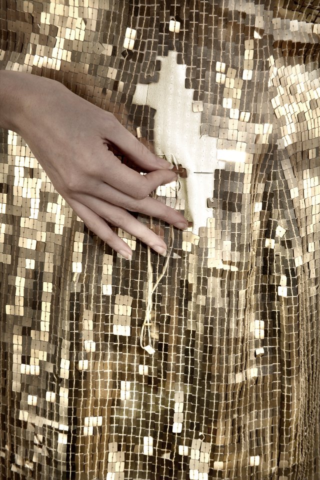 Gold sequin dress being mended