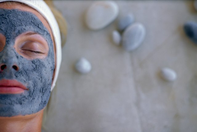 Woman with eyes closed wearing mud mask
