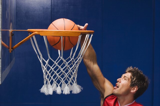 Man dunking basketball