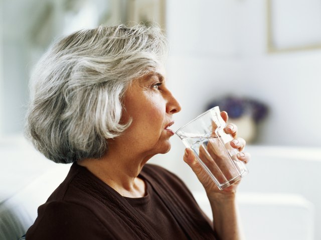 Senior woman drinking water, close-up, side view