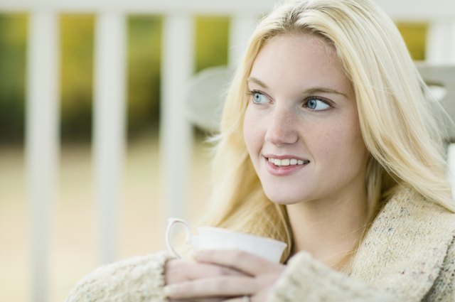Young woman holding tea cup outdoors