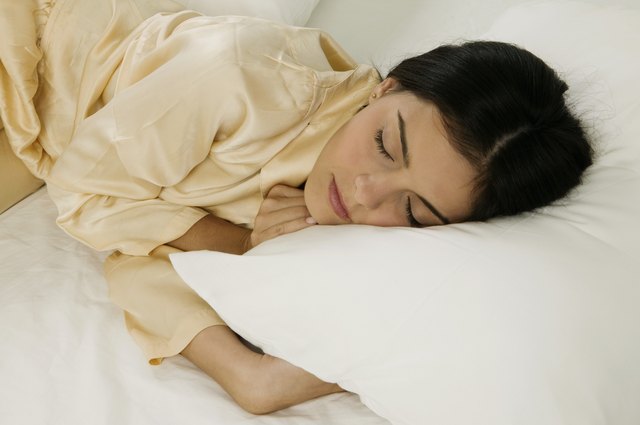 High angle view of a young woman sleeping on a bed