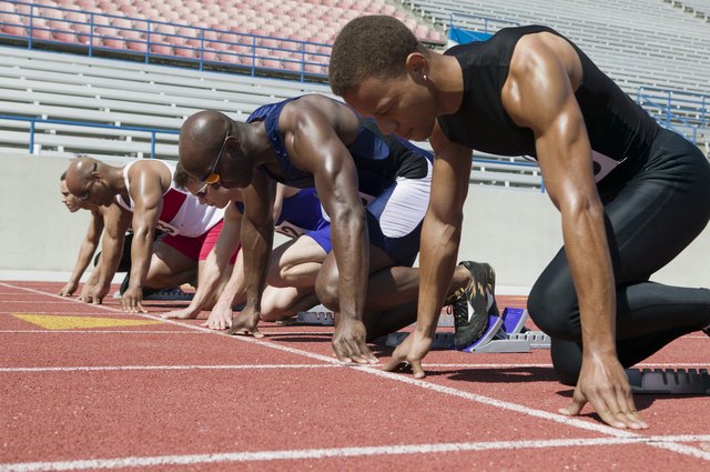 Male sprinters in starting blocks