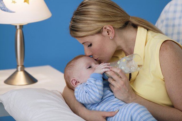 Mother giving son a bottle