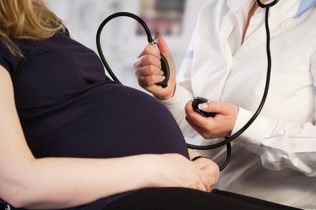 Pregnant woman having her blood pressure checked
