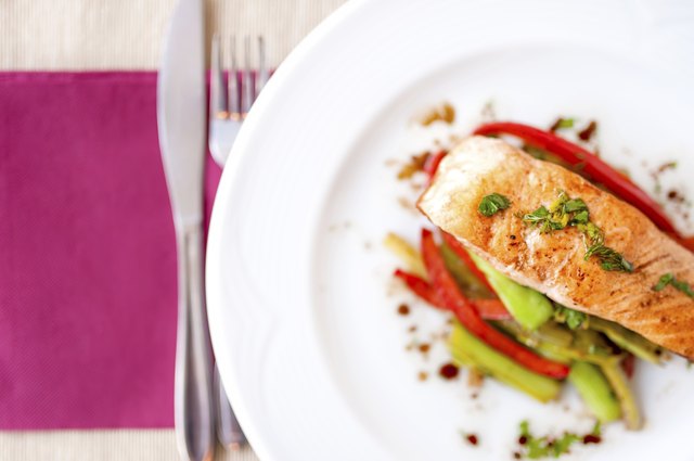 grilled smoked salmon fillet close-up with vegetables and sauce