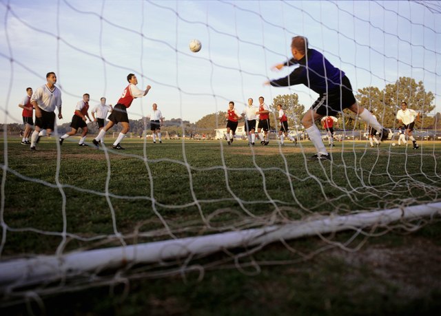 Goalkeeper making dash towards ball, low angle view