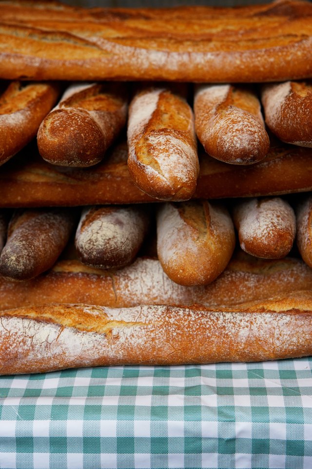 Baguettes stacked together on market stall, close-up