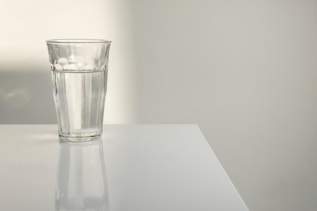 Glass of water on white table