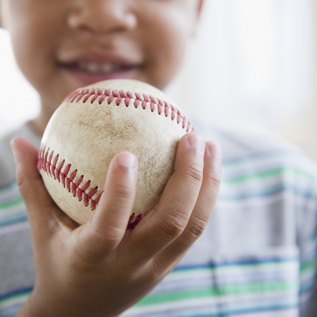 African American boy holding baseball