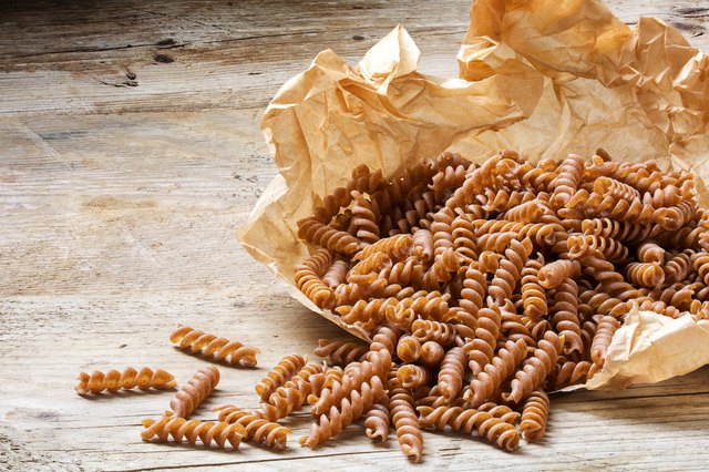 wholemeal pasta fusilli from organic whole grain spelt on paper