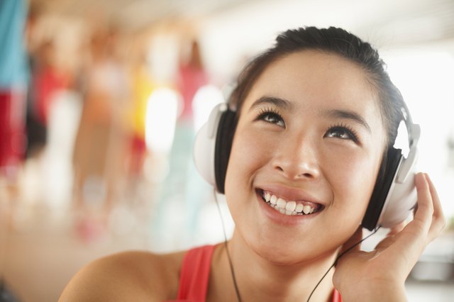 Young women listening to music, portrait