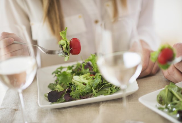 USA, New Jersey, Jersey City, Midsection of woman eating salad