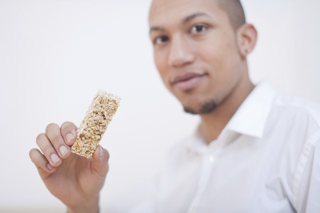 Young African-American Man Eating Cereal Bar