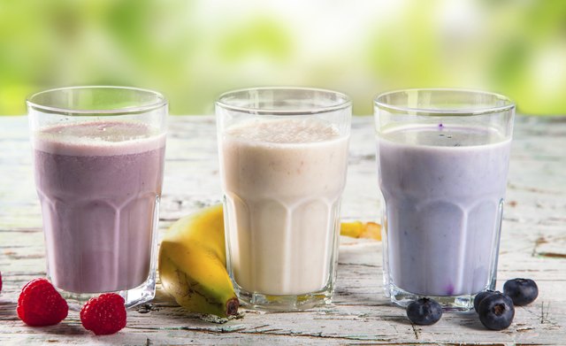 Fresh fruits milk shake on wood