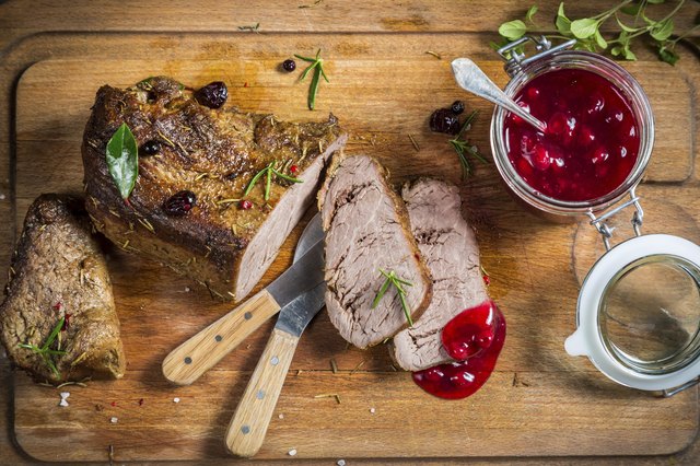 Freshly served venison with cranberries and rosemary