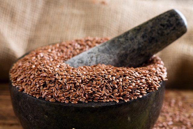 Marble stone mortar full of flax seeds