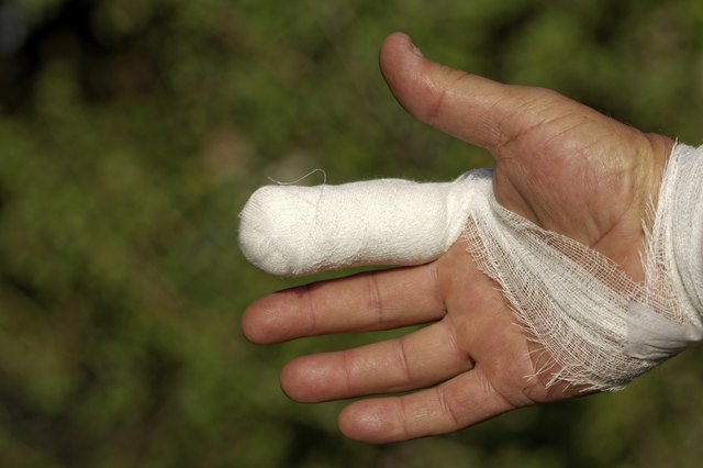 White medicine bandage on human injury hand finger