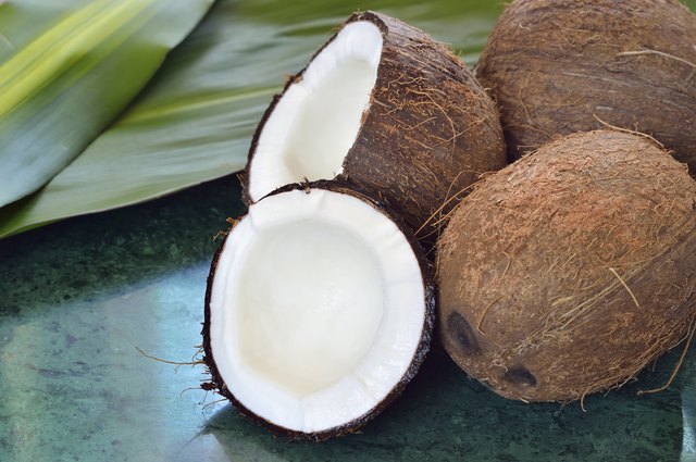 Few coconuts on green marble slab