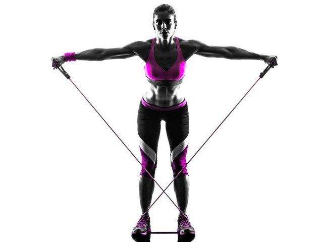 one caucasian woman exercising fitness resistance bands in studio silhouette isolated on white background
