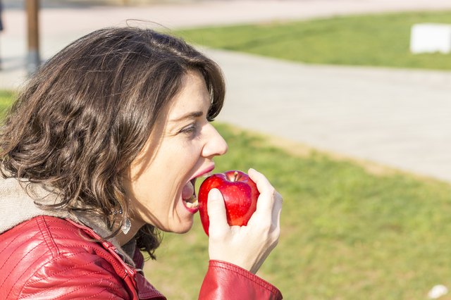 Woman biting an apple