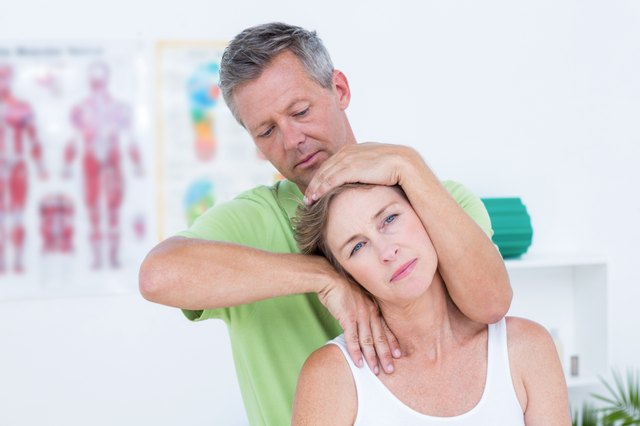 Doctor doing neck adjustment