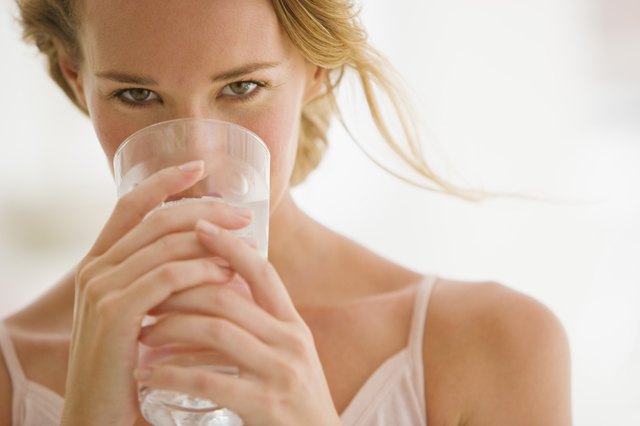 Woman holding glass of water