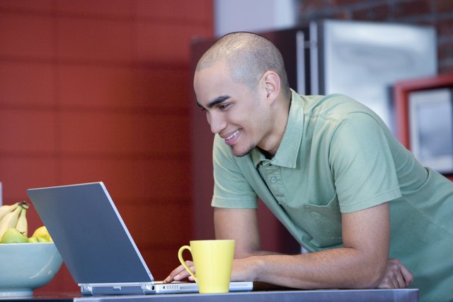African American man looking at laptop