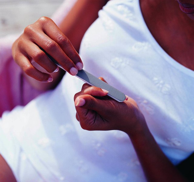 Woman Filing her Nails