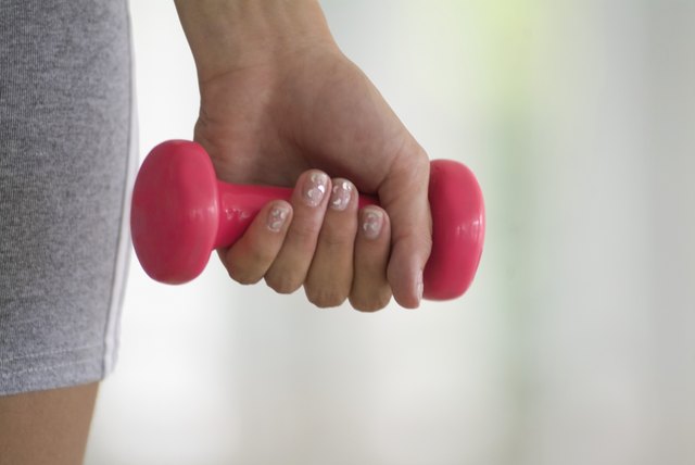 Person using hand weight, close-up