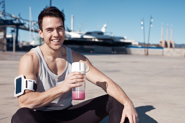 Smilingl athlete with protein cocktail