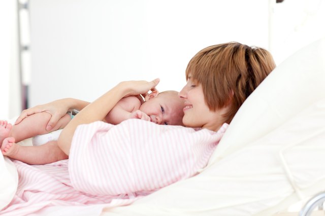 Mother embracing her newborn baby