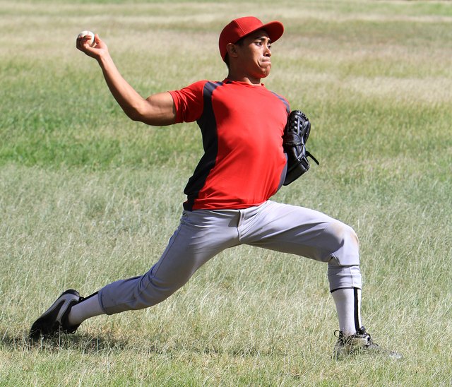 Baseball player throws a ball with strength